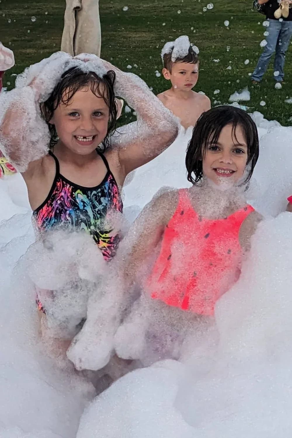 Two girls covered in foam